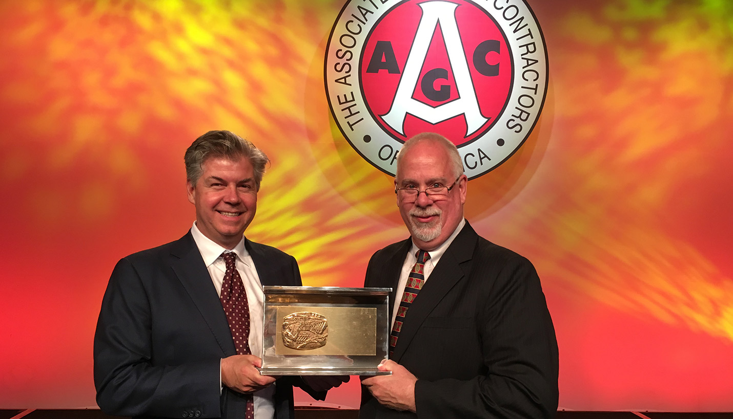 Thomas McCarthy of Page & Tim McCoy of B.L. Harbert accept the AGC 2016 Alliant Build America Award for the top International project for the U.S. Embassy Office Annex in Abuja, Nigeria. - Associated General Contractors of America