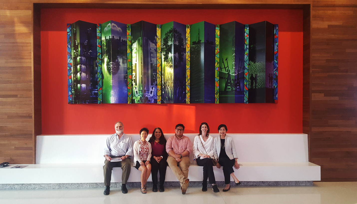 Some of the Pagers who participated in the Novum walking tour posed for a photo underneath Page Senior Associate Tami Merrick's artwork in the George R. Brown Convention Center. - Novum Structures