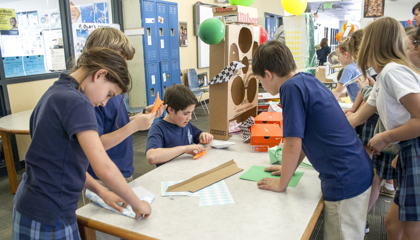 Trinity Episcopal students prepare paper airplanes for testing their STEAM game creation during the school's annual STEAMFest. - Page