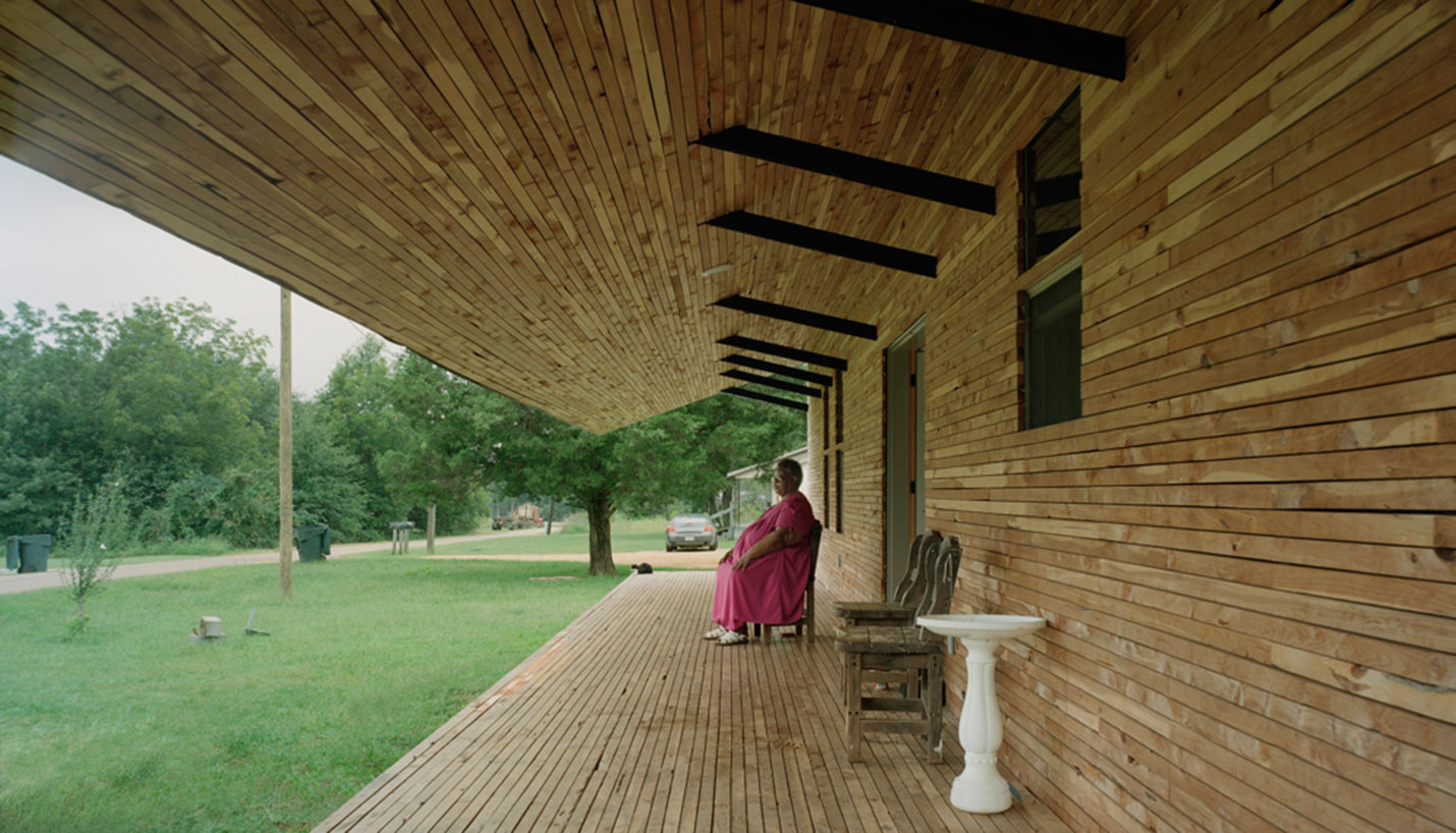 Rose Lee Turner sits on the porch of the house that Katie Woods and her Rural Studio classmates designed and built for her. - © Timothy Hursley, courtesy of Auburn University Rural Studio