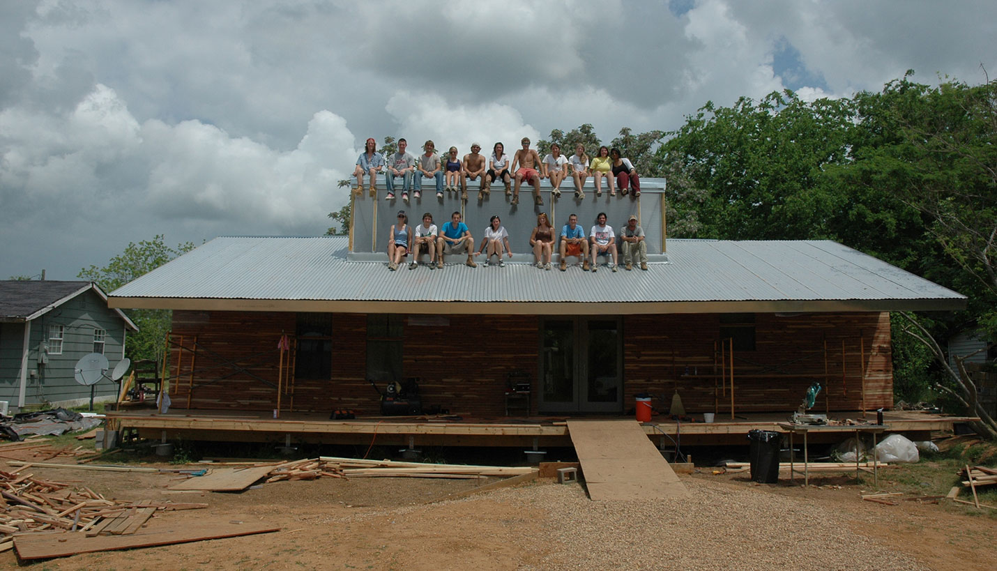 Katie Woods, seated center on the bottom row, and her classmates perch on top of Rose Lee Turner's house during construction. - © Timothy Hursley, courtesy of Auburn University Rural Studio
