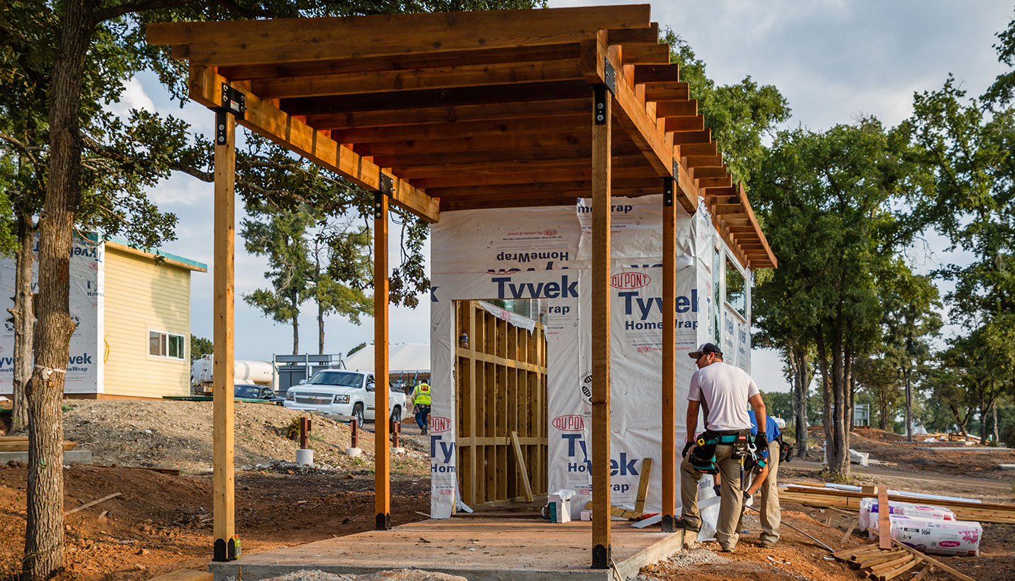 Volunteer members of the Community First! Village construction teams weatherproof a Porch With A Home designed by Page. - Jessica Mims, See In See Out Photography