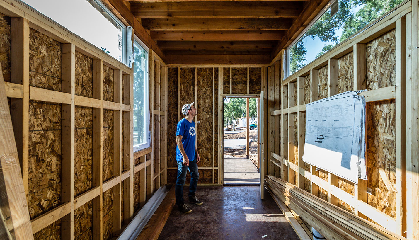 A member of the Community First! Village volunteer team checks out the interior structure of Porch With A Home. - Jessica Mims, See In See Out Photography