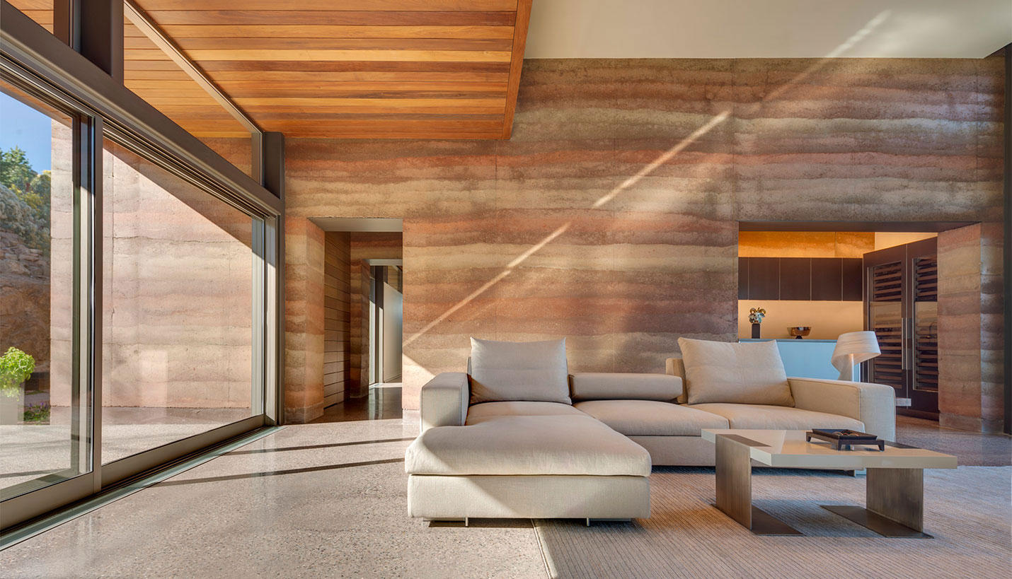 The rammed earth walls in the Torcasso residence incorporate four different shades of indigenous soil, creating a deep luscious palette in irregular sedimentary layers. - © Robert Reck
