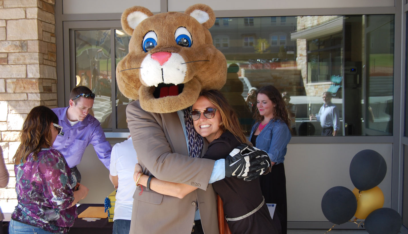 The UCCS mountain lion mascot poses with Page Marketing Coordinator Jaclyn Wenaas - 